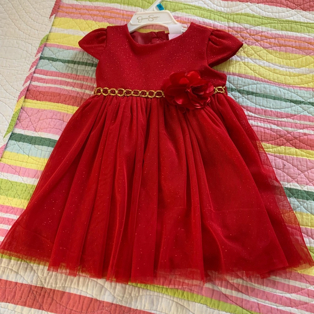 Beautiful dress. New with tags. Red flower and gold detail chain.